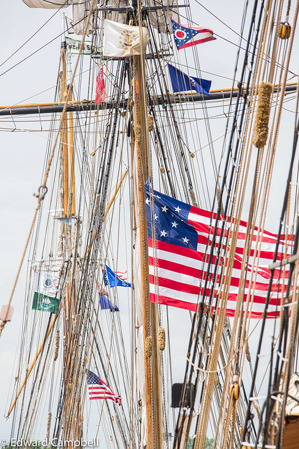 The 1812-era 15 star American Flag flies over the Pride of Baltimore II, a modern replica of its namesake that fought in the War of 1812.